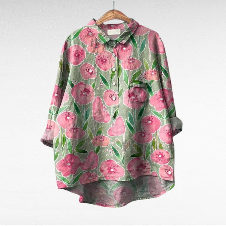 A woman wearing an elegant printed summer blouse with pants, looking cool and stylish on a warm day.