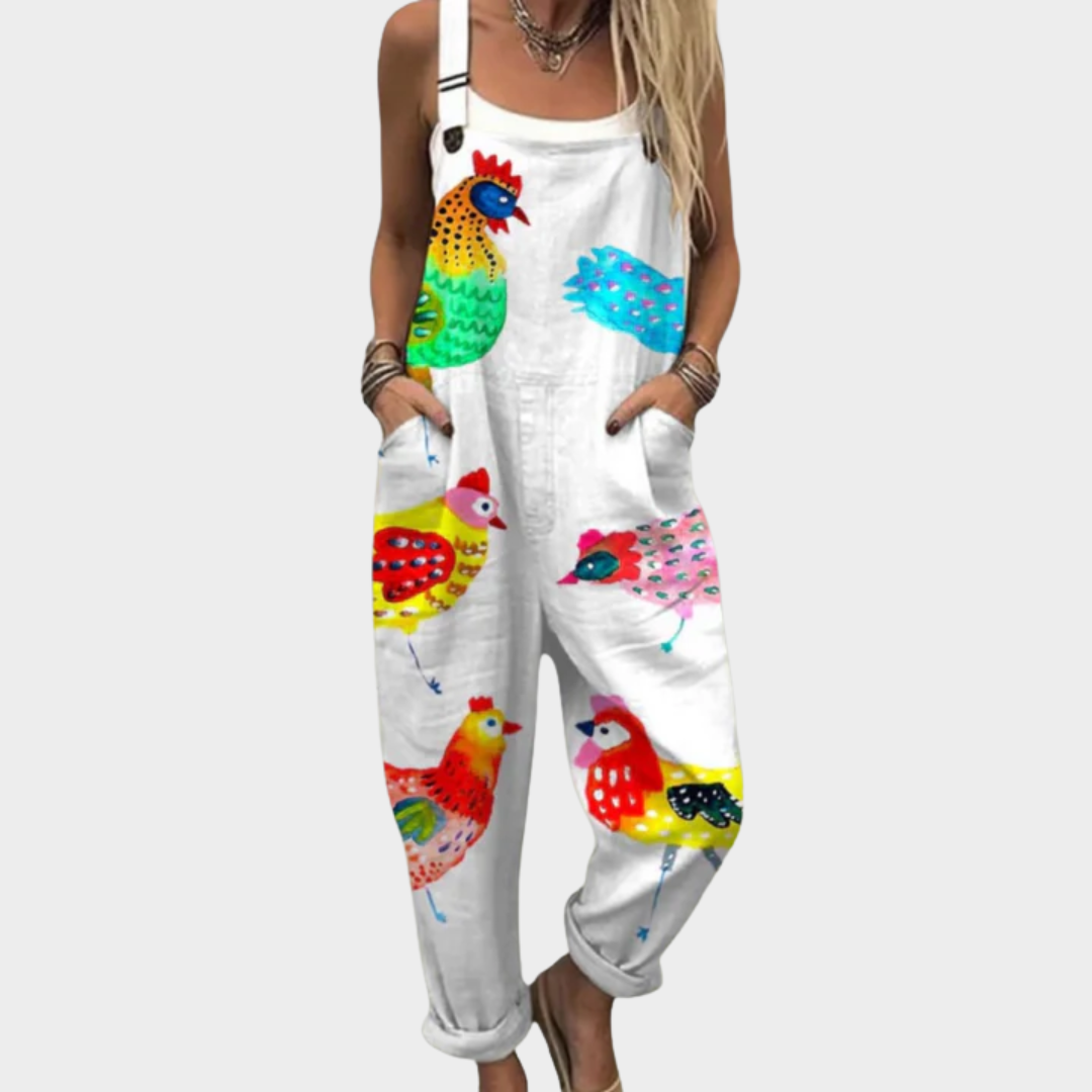 Woman wearing white overalls printed with a cheerful flock of colourful hens