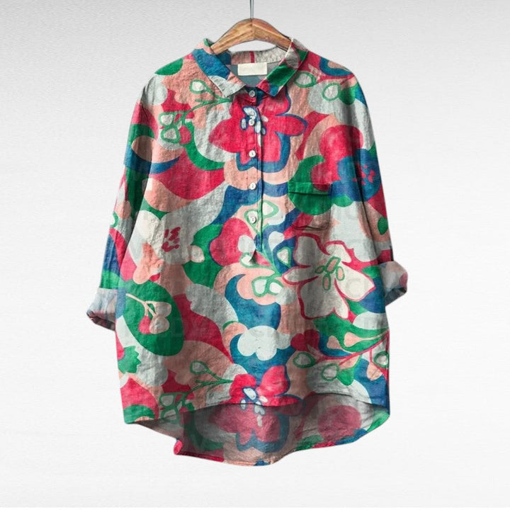 A woman wearing an elegant printed summer blouse with pants, looking cool and stylish on a warm day.