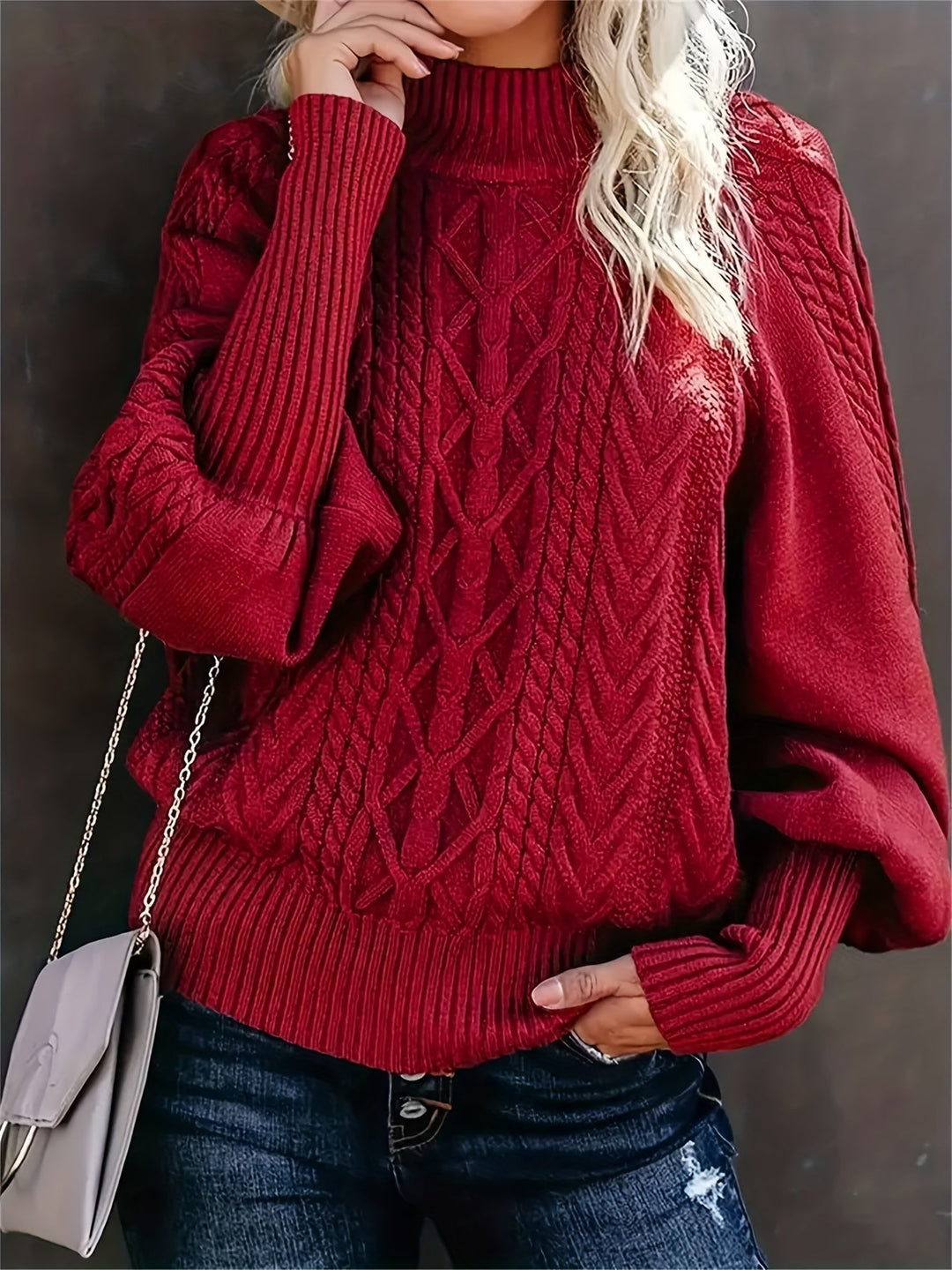 A woman wearing a long, relaxed sweater with long sleeves, soft and cosy for everyday wear.