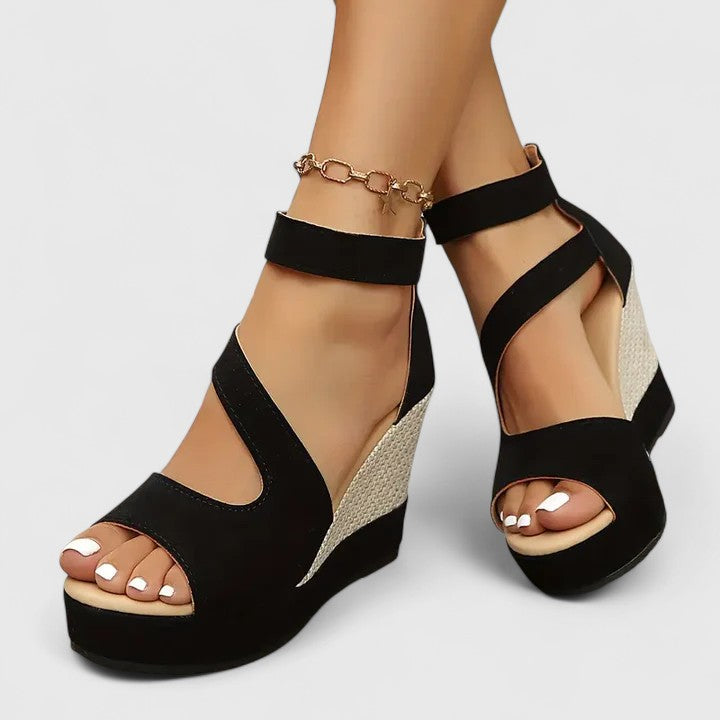 A woman walking gracefully in wide-fit wedge sandals with adjustable supportive straps.