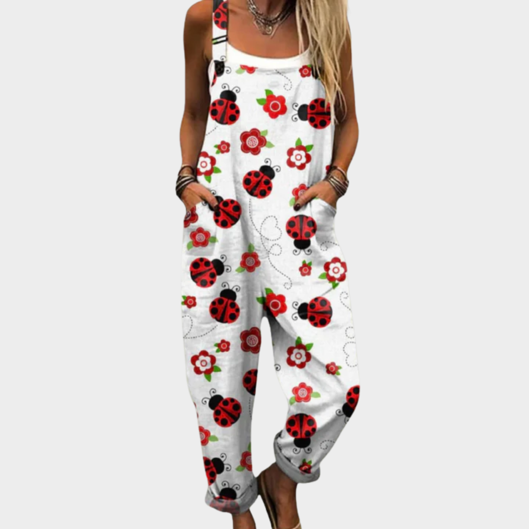 Woman wearing white overalls printed with cheerful red ladybirds and small red blooms