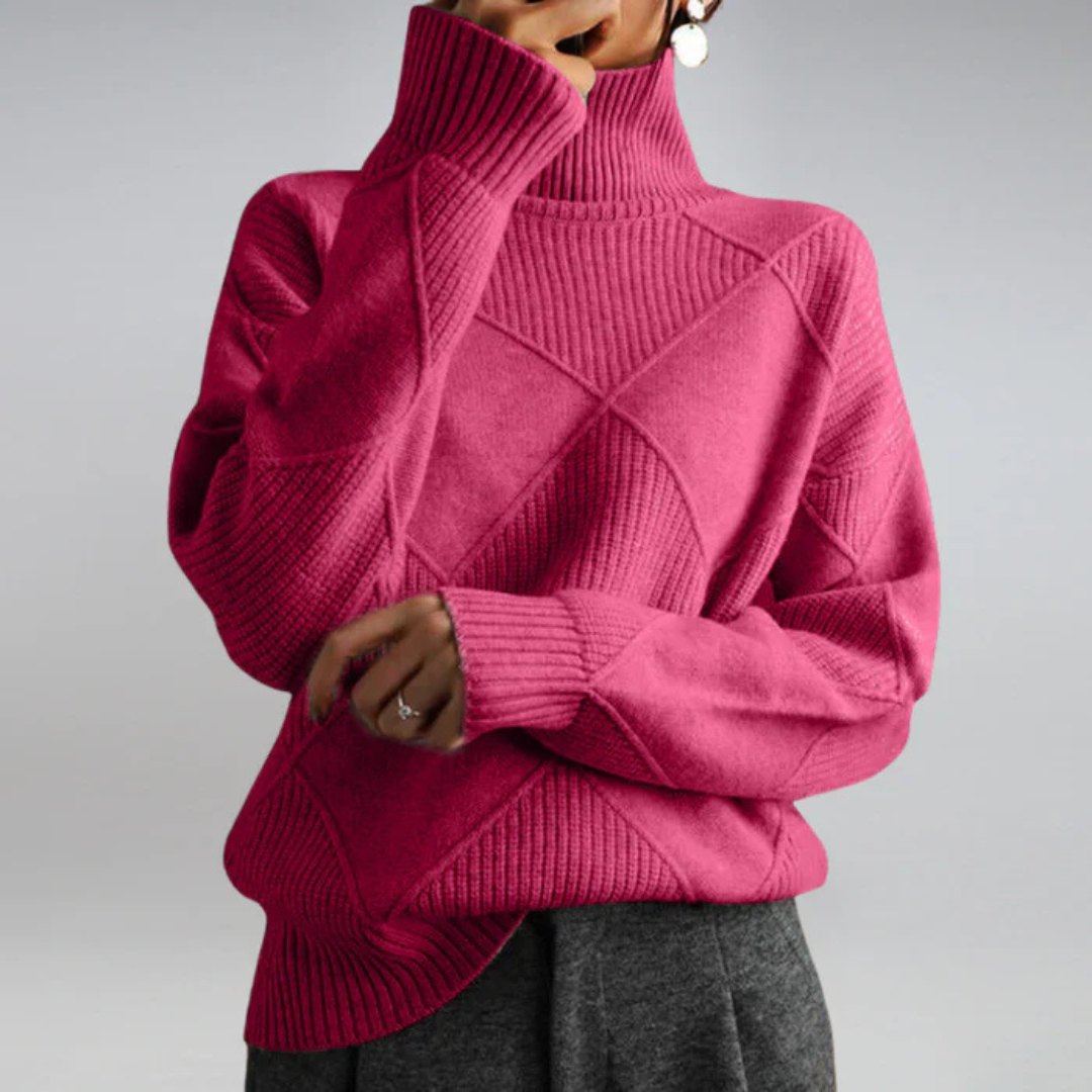 A woman in a stand-collar sweater with an elegant drape, styled with tailored pants.