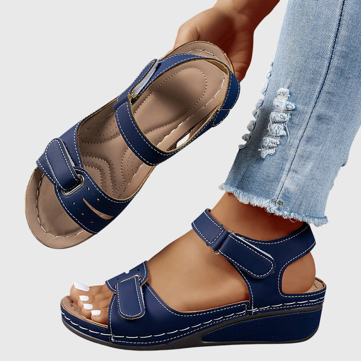 A woman wearing wide-fit supportive sandals with a relaxed summer outfit, walking with ease and confidence.