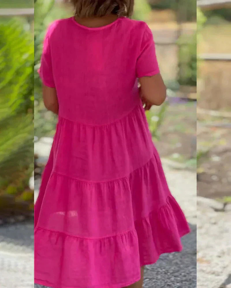 Woman wearing the Bonnie™ V-neck summer dress with a soft layered skirt, strolling on a sunny afternoon.