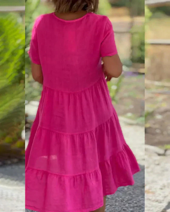Woman wearing the Bonnie™ V-neck summer dress with a soft layered skirt, strolling on a sunny afternoon.