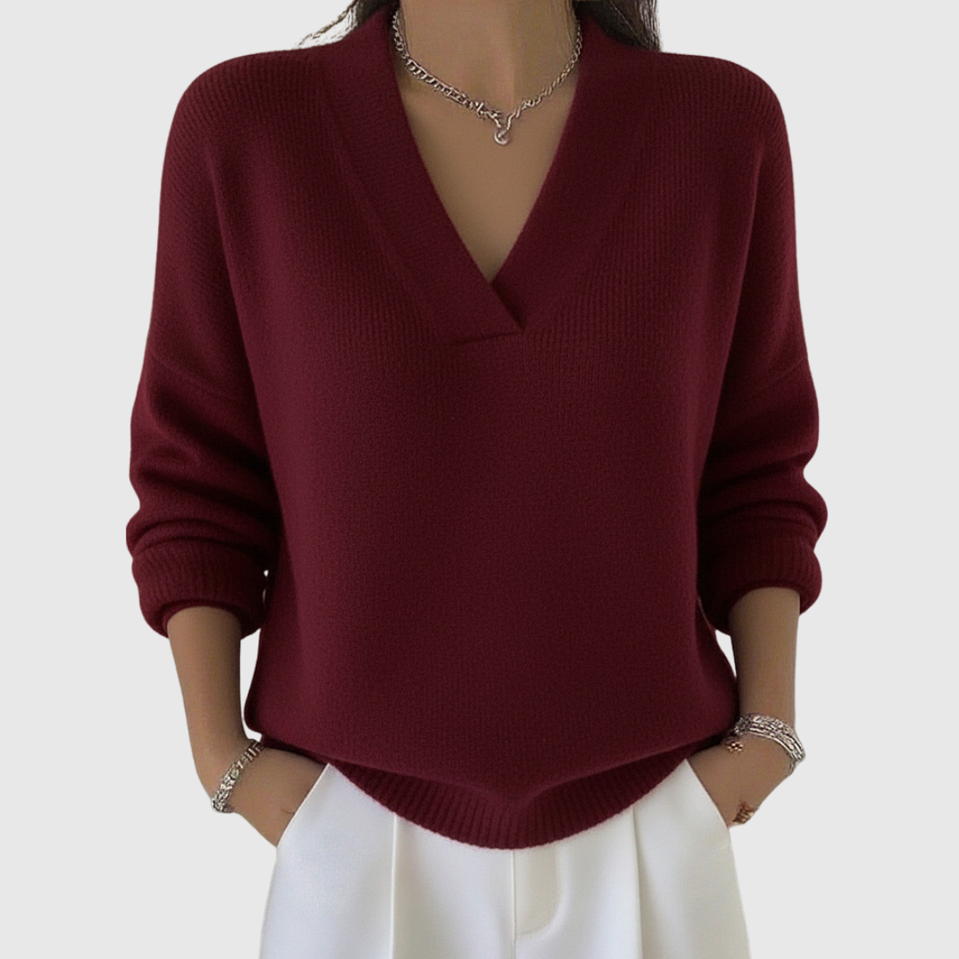 A woman wearing a soft draped V-neck sweater with jeans for an effortlessly elegant look.