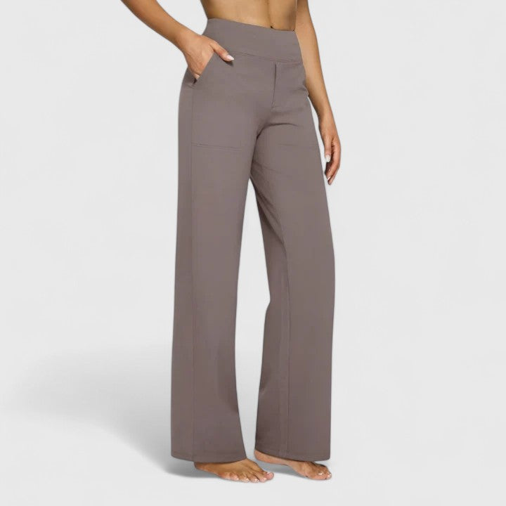 Woman wearing pull-on pants with a soft blouse, relaxed and comfortable at home.