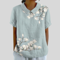 A woman wearing a floral top with a polo collar on a relaxed day out