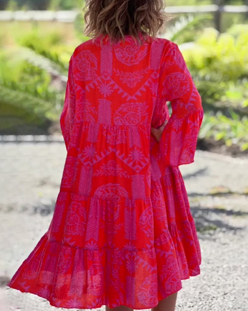 Woman in a loose boho print midi dress enjoying a relaxed day outdoors.