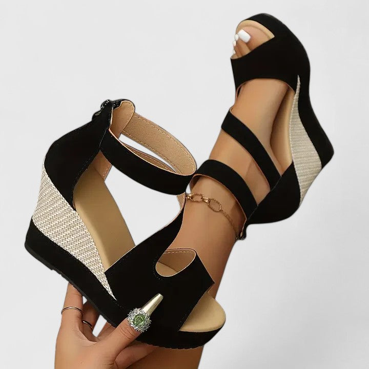 A woman walking gracefully in wide-fit wedge sandals with adjustable supportive straps.