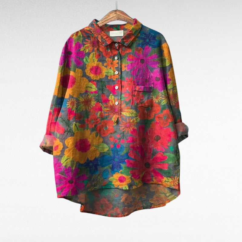 Woman wearing a multicolour printed summer blouse with a light, flattering drape.