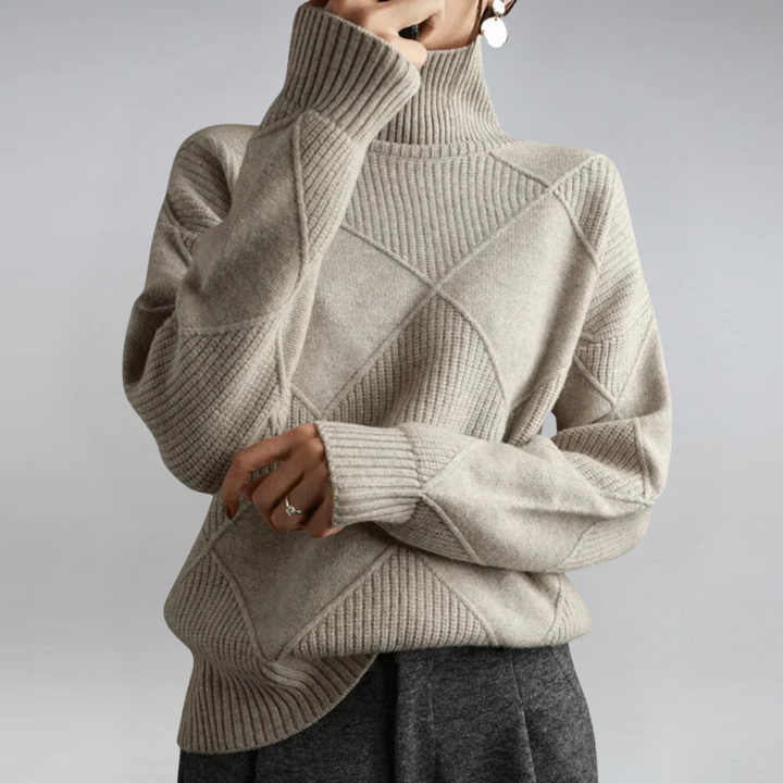 A woman in a stand-collar sweater with an elegant drape, styled with tailored pants.