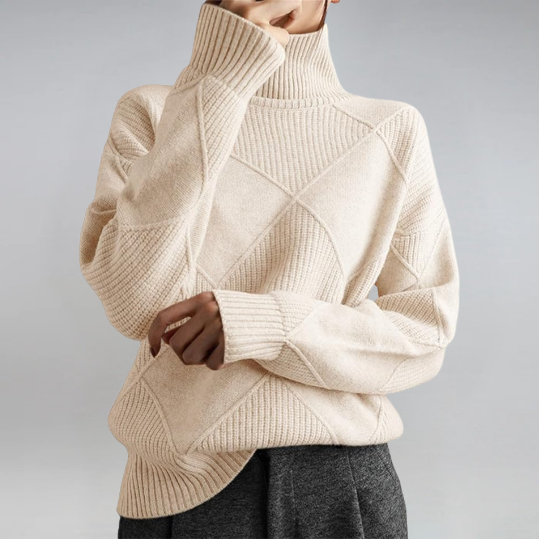 A woman in a stand-collar sweater with an elegant drape, styled with tailored pants.