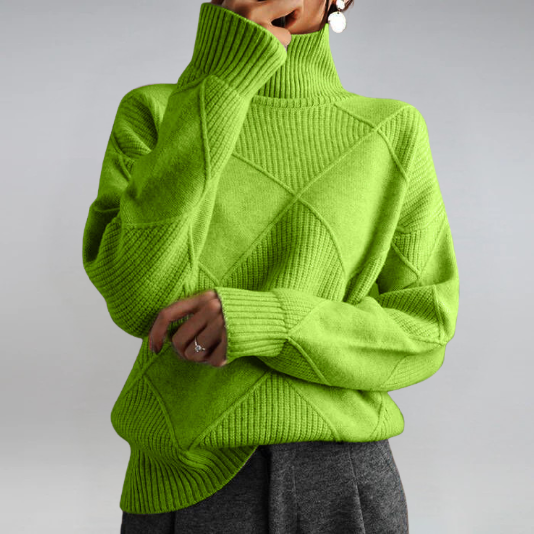 A woman in a stand-collar sweater with an elegant drape, styled with tailored pants.