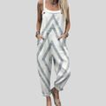 A woman wearing white overalls with a soft blue-grey zigzag pattern, relaxed and at ease in town.