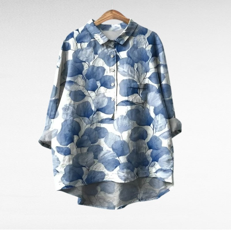 Woman wearing a printed summer blouse with a gentle, flattering drape.