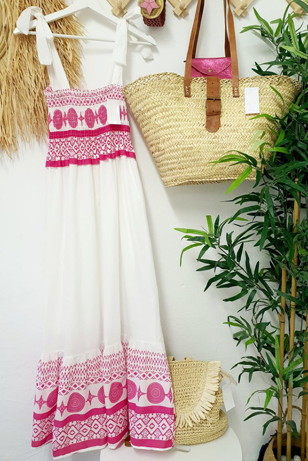 Woman wearing the Sara™ boho print maxi dress with a gathered bodice, enjoying a warm summer day outdoors.