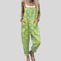 A woman wearing overalls with a bright yellow and turquoise retro geometric pattern, smiling on a sunny day.