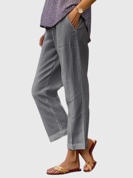 A woman wearing elegant tailored pants with a flattering straight-leg cut and clean lines.