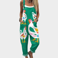 A woman in green overalls with a playful hen print, relaxed fit and adjustable straps.