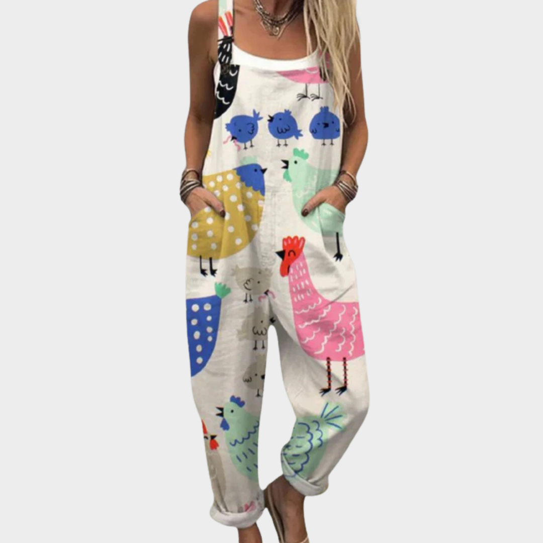 Woman wearing cream overalls printed with colourful hens, little blue chicks and proud cockerels