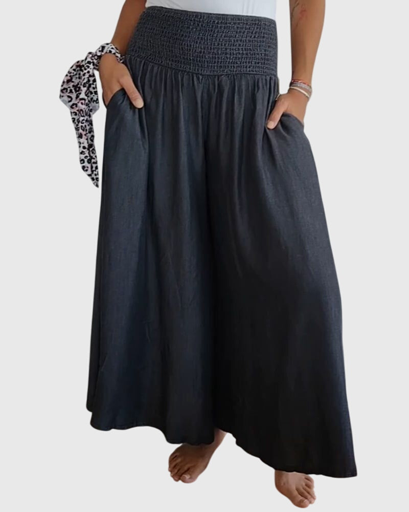 A woman in wide-leg pants with a high elastic waist, styled for a relaxed boho look.