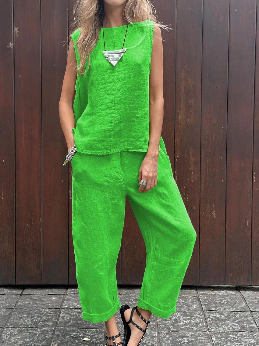 A woman wearing a relaxed sleeveless top with ankle-length pants, easy and elegant.
