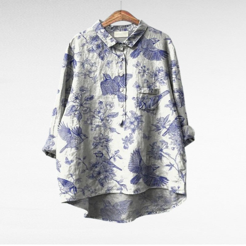 Woman wearing a flowing summer blouse with an elegant all-over print.