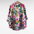 Woman wearing a flowing summer blouse with an elegant all-over print.