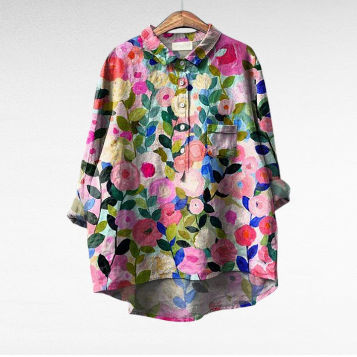 Woman wearing a flowing summer blouse with an elegant all-over print.