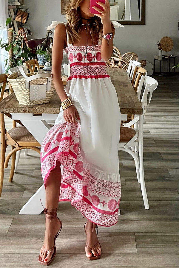 Woman wearing the Sara™ boho print maxi dress with a gathered bodice, enjoying a warm summer day outdoors.