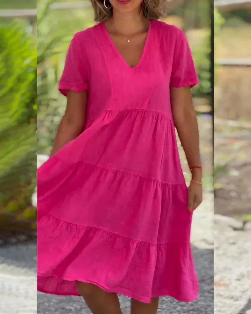 Woman wearing the Bonnie™ V-neck summer dress with a soft layered skirt, strolling on a sunny afternoon.