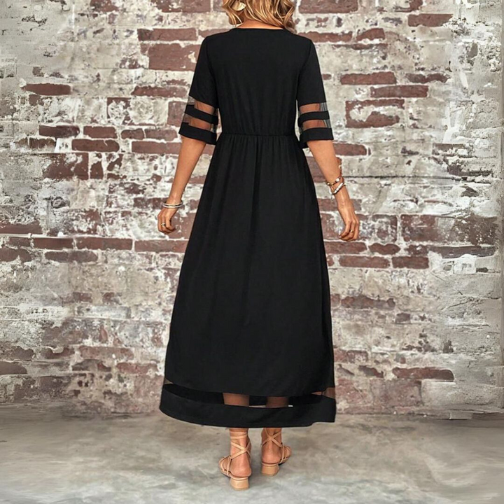 Woman wearing the Colleen™ empire waist midi dress with a flowing skirt and round neckline at a family gathering.