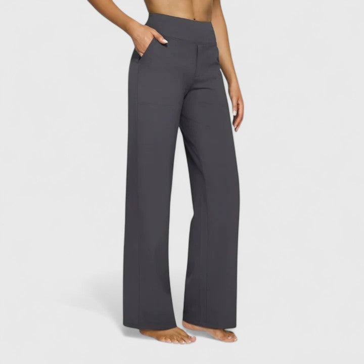 Woman wearing pull-on pants with a soft blouse, relaxed and comfortable at home.