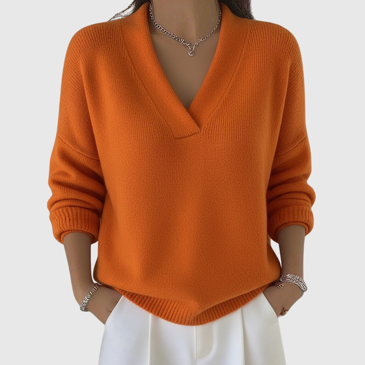 A woman wearing a soft draped V-neck sweater with jeans for an effortlessly elegant look.