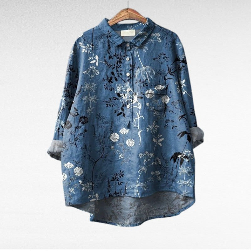 Woman wearing a flowing summer blouse with an elegant all-over print.