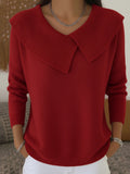 A woman wearing a soft collared sweater styled elegantly for a festive occasion.
