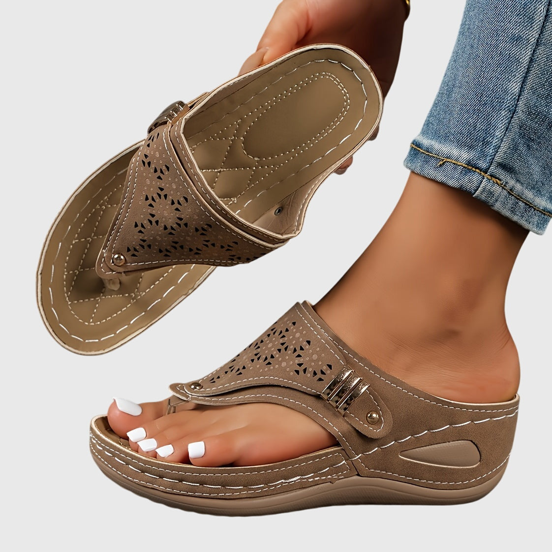 A woman in grey comfort flip-flops relaxing outdoors, feet cushioned and supported.
