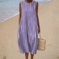 A woman wearing a sleeveless printed summer dress, relaxed and cool on a bright summer day.