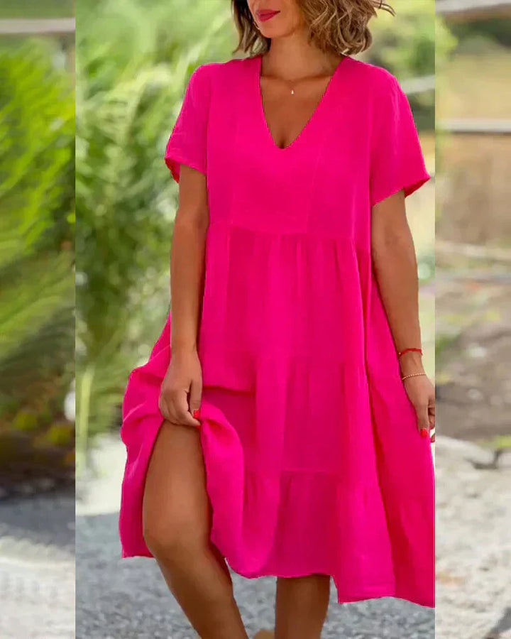 Woman wearing the Bonnie™ V-neck summer dress with a soft layered skirt, strolling on a sunny afternoon.