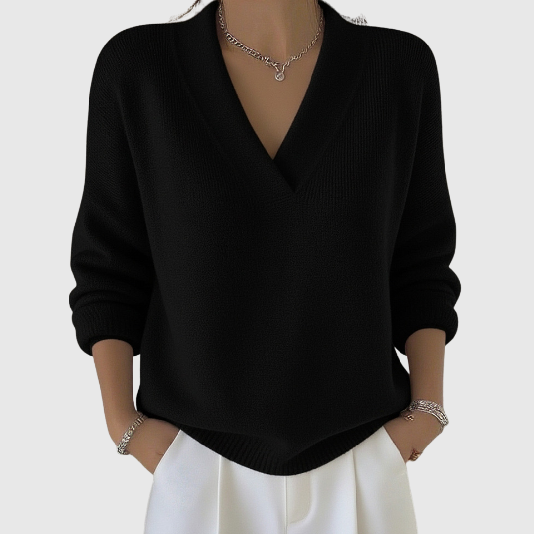 A woman wearing a soft draped V-neck sweater with jeans for an effortlessly elegant look.