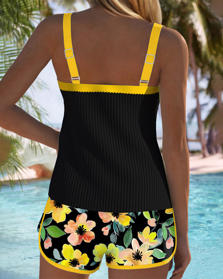A woman at the water's edge in a bright printed two-piece tankini, relaxed and confident.