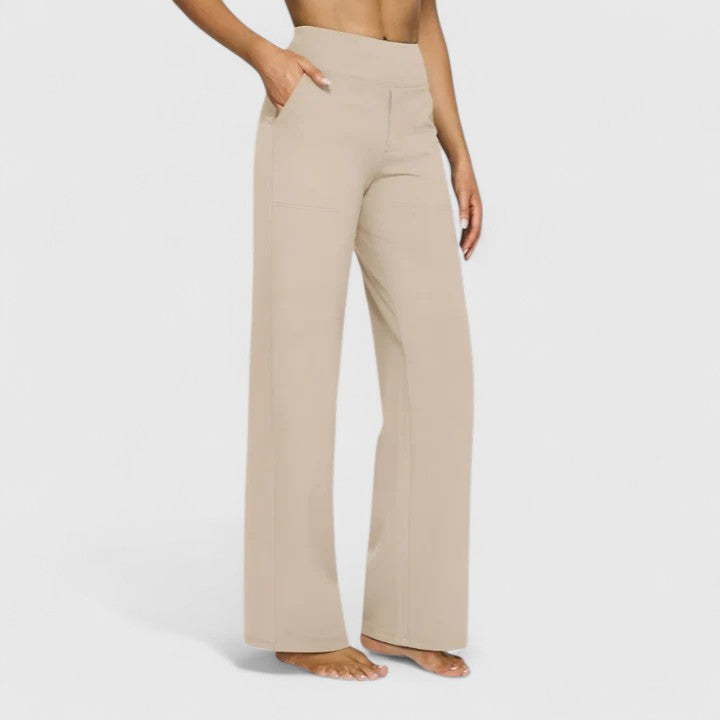 Woman wearing pull-on pants with a soft blouse, relaxed and comfortable at home.