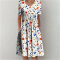 Woman wearing the floral midi dress with pockets, walking outdoors on a sunny day.