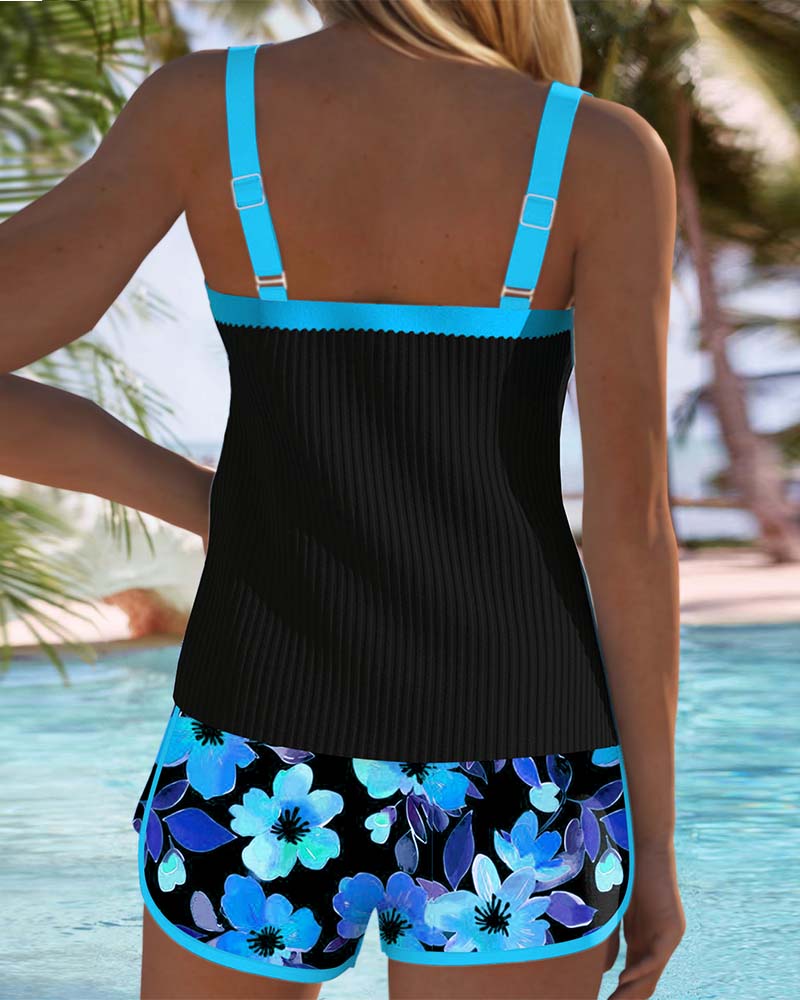 A woman at the water's edge in a bright printed two-piece tankini, relaxed and confident.