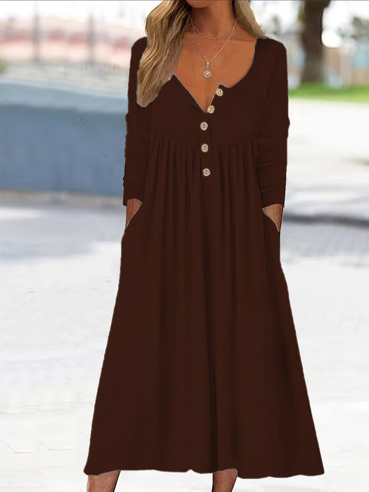 A woman wearing the Tina button-front midi dress with an A-line skirt, dressed for a casual day out.