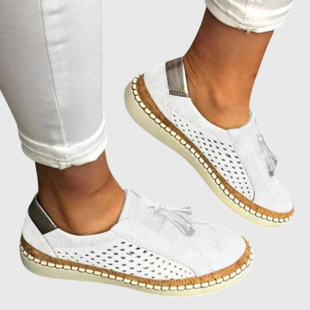 A woman wearing comfortable orthopaedic slip-on shoes on a summer day