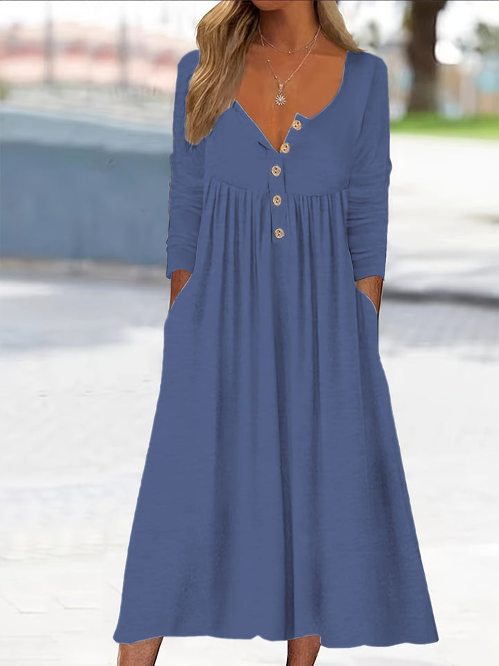 A woman wearing the Tina button-front midi dress with an A-line skirt, dressed for a casual day out.