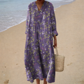 A woman wearing a soft printed summer dress with a gentle, flowing drape at a summer gathering.